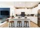 Modern kitchen with white cabinets, an island with bar seating, and stainless steel appliances at 18 Relaxing Way, Pittsboro, NC 27312