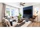 Cozy living room with modern furnishings, including a dark blue accent wall and stylish decor at 18 Relaxing Way, Pittsboro, NC 27312