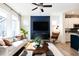 Open-concept living room featuring modern furnishings, a television, and views into the kitchen and dining area at 18 Relaxing Way, Pittsboro, NC 27312