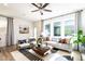 Bright living room with stylish furniture, large windows, modern decor, and a ceiling fan at 18 Relaxing Way, Pittsboro, NC 27312