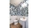 Chic powder room with eye-catching wallpaper and modern fixtures, plus a pedestal sink at 18 Relaxing Way, Pittsboro, NC 27312