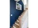 Stylish staircase with wood and white trim, complemented by a bold blue accent wall at 18 Relaxing Way, Pittsboro, NC 27312
