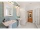 Bathroom with double sinks, decorative tile flooring, and subway tile walls at 1870 Lennox Dr, Garner, NC 27529