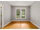This bedroom features hardwood floors, a window with a view, and light gray walls at 1870 Lennox Dr, Garner, NC 27529
