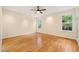 This bedroom features hardwood floors, recessed lighting, a ceiling fan, and two large windows at 1870 Lennox Dr, Garner, NC 27529