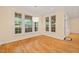 Bright breakfast nook features hardwood floors, neutral walls, large windows, and modern light fixture at 1870 Lennox Dr, Garner, NC 27529