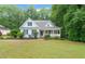 Charming light-blue home with a welcoming front porch and beautifully landscaped front yard at 1870 Lennox Dr, Garner, NC 27529