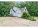 Charming light blue home with a well-manicured lawn, a two-car garage, and mature trees at 1870 Lennox Dr, Garner, NC 27529