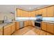 Well-lit kitchen featuring stainless steel appliances, granite counters, and wooden cabinets at 1870 Lennox Dr, Garner, NC 27529