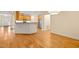 Open-concept kitchen with wooden cabinets, breakfast bar, and hardwood flooring at 1870 Lennox Dr, Garner, NC 27529