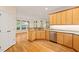 Open kitchen layout with wooden cabinets, granite counters, and ample lighting at 1870 Lennox Dr, Garner, NC 27529