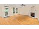Bright living room with hardwood floors, fireplace, and access to a porch at 1870 Lennox Dr, Garner, NC 27529