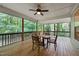 Relaxing screened porch with wood flooring and wooded views, creating a serene outdoor retreat at 1870 Lennox Dr, Garner, NC 27529