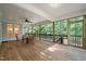 Inviting screened porch with wood flooring and ceiling fan, perfect for outdoor dining and relaxation at 1870 Lennox Dr, Garner, NC 27529