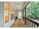 Cozy screened porch with wood flooring, offering a relaxing outdoor space and wooded views at 1870 Lennox Dr, Garner, NC 27529