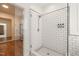 Modern shower with subway tile walls, glass door, and decorative tile flooring at 1870 Lennox Dr, Garner, NC 27529
