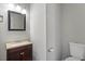 Bathroom vanity features granite countertop and framed mirror at 2010 Silky Dogwood Trl, Apex, NC 27502