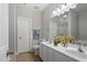 Bright bathroom features a double sink vanity, large mirror, separate toilet, and shower area at 2010 Silky Dogwood Trl, Apex, NC 27502