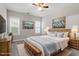 Comfortable bedroom with a ceiling fan, carpet, and art prints hanging above the bed and on the wall at 2010 Silky Dogwood Trl, Apex, NC 27502