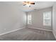 Empty bedroom with carpeting, neutral walls, bright windows, and a ceiling fan at 2010 Silky Dogwood Trl, Apex, NC 27502