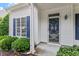 Close-up of the home's front door, showcasing detailed trim and blue shutters at 2010 Silky Dogwood Trl, Apex, NC 27502