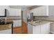 Modern kitchen with white cabinets, granite countertops, and stainless steel appliances at 2010 Silky Dogwood Trl, Apex, NC 27502