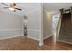 Open-concept living area featuring hardwood floors, neutral walls, and staircase at 2010 Silky Dogwood Trl, Apex, NC 27502