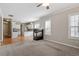 Open-concept living space with a cozy fireplace, seamless transition from carpet to hardwood floors at 2010 Silky Dogwood Trl, Apex, NC 27502