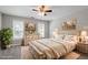 Bright main bedroom with neutral tones, ceiling fan, two windows, and carpeted flooring at 2010 Silky Dogwood Trl, Apex, NC 27502