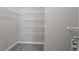 Walk-in closet with wall to wall shelving at 2010 Silky Dogwood Trl, Apex, NC 27502