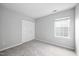 Empty bedroom with carpet and large closet, as well as a window providing natural light at 2018 Grassy Banks Dr, Raleigh, NC 27610