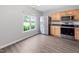 Bright dining area featuring wood-look flooring, stainless steel refrigerator and ample natural light at 2018 Grassy Banks Dr, Raleigh, NC 27610