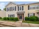 Two-story townhome featuring black shutters, neutral siding, and landscaping at 2018 Grassy Banks Dr, Raleigh, NC 27610