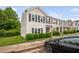Exterior view of townhome with dark shutters, sidewalk, and manicured lawn at 2018 Grassy Banks Dr, Raleigh, NC 27610