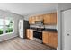 Modern kitchen with stainless steel refrigerator and appliances with wood-look flooring and light cabinets at 2018 Grassy Banks Dr, Raleigh, NC 27610