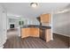 Open concept kitchen with stainless steel dishwasher and light cabinets, flowing into the living area at 2018 Grassy Banks Dr, Raleigh, NC 27610