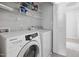 Laundry room with a modern Samsung washer and dryer and wire shelving for storage at 2018 Grassy Banks Dr, Raleigh, NC 27610