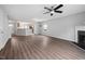 Open-concept living room with hardwood flooring, a fireplace, and a ceiling fan at 2018 Grassy Banks Dr, Raleigh, NC 27610