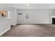 Open-concept living room with neutral walls, wood-look flooring, and abundant natural light at 2018 Grassy Banks Dr, Raleigh, NC 27610
