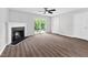 Bright living room featuring a fireplace, ceiling fan, and sliding glass doors to the patio at 2018 Grassy Banks Dr, Raleigh, NC 27610