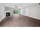 Bright living room featuring a fireplace, ceiling fan, and sliding glass doors to the patio at 2018 Grassy Banks Dr, Raleigh, NC 27610