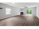 Open-concept living room with neutral walls, wood-look flooring, and abundant natural light at 2018 Grassy Banks Dr, Raleigh, NC 27610