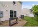 Back patio features sliding doors, AC unit, and outdoor garden planter at 2018 Grassy Banks Dr, Raleigh, NC 27610