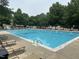 Large community swimming pool surrounded by lounge chairs for relaxing by the water at 2018 Grassy Banks Dr, Raleigh, NC 27610