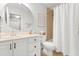 Bright bathroom featuring a vanity with a round mirror and a shower with a patterned shower curtain at 203 Witheridge Ct, Apex, NC 27502