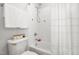 This bright bathroom features a shower over tub with a stylish shower curtain and a toilet with decor at 203 Witheridge Ct, Apex, NC 27502