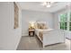 Cozy bedroom with a white bed frame, neutral carpet, and a window letting in natural light at 203 Witheridge Ct, Apex, NC 27502