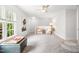 Bright bonus room with a ceiling fan, natural light, and neutral walls and carpet at 203 Witheridge Ct, Apex, NC 27502