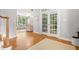 Bright foyer leading to living spaces with hardwood floors and neutral paint at 203 Witheridge Ct, Apex, NC 27502