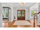Grand foyer with hardwood floors, a chandelier, and staircase at 203 Witheridge Ct, Apex, NC 27502